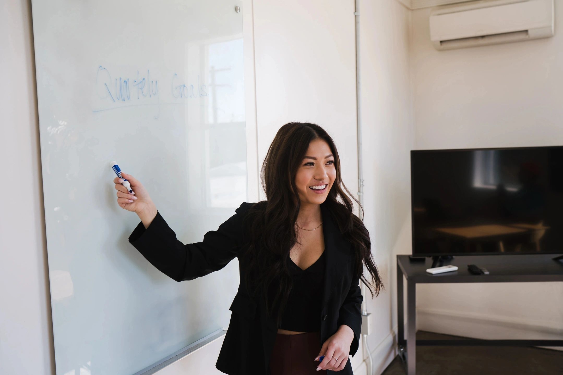 woman explaining something on a whiteboard