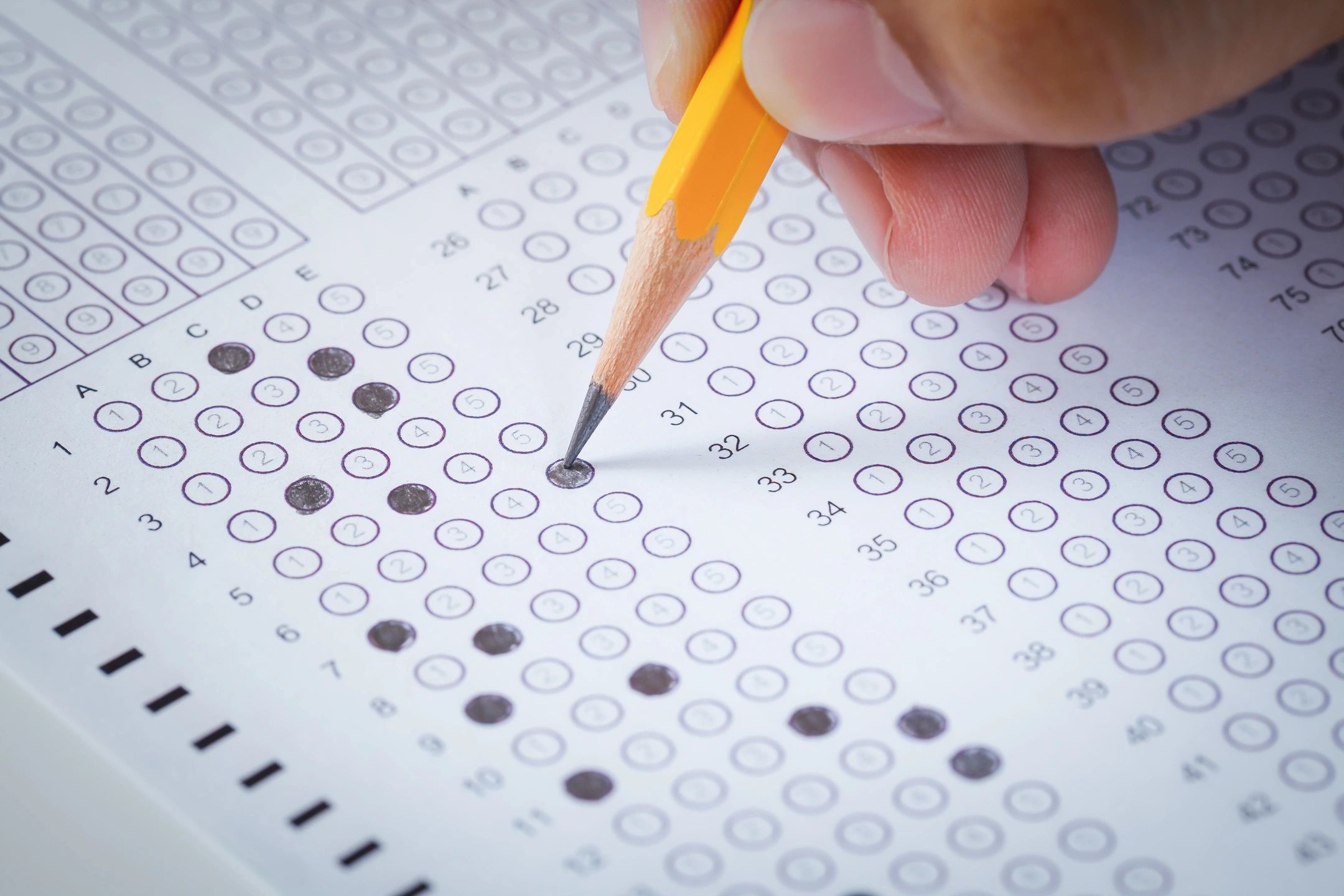 filling in bubbles on a test form with a pencil